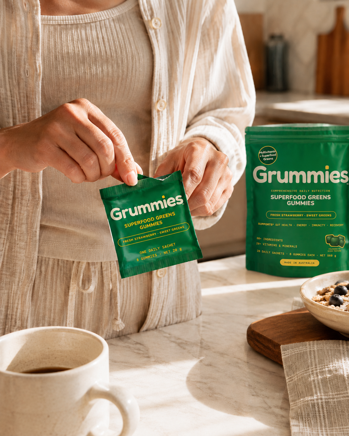 A hand tearing a sachet open above a bench with gummies scattering across the surface