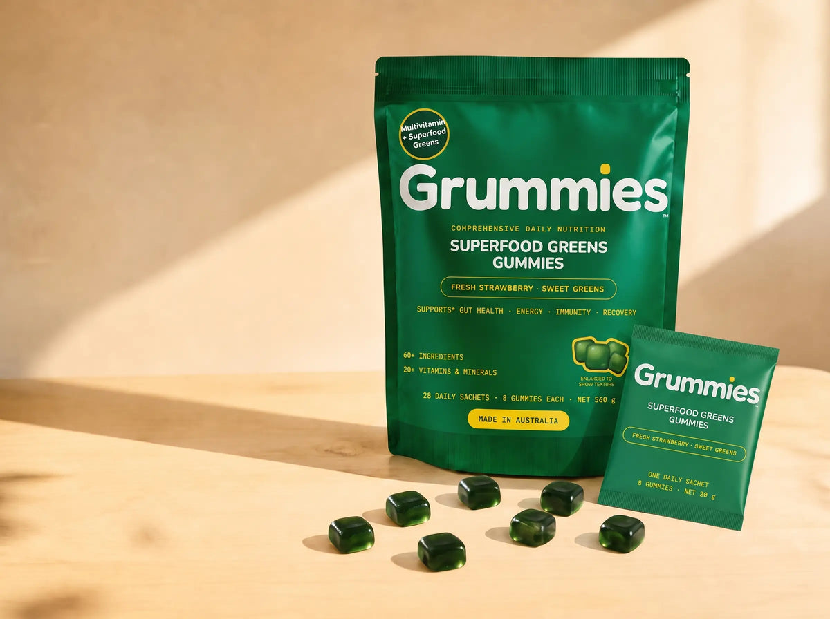 Grummies pouch with one torn sachet and a loose spill of gummies on a sunlit bench